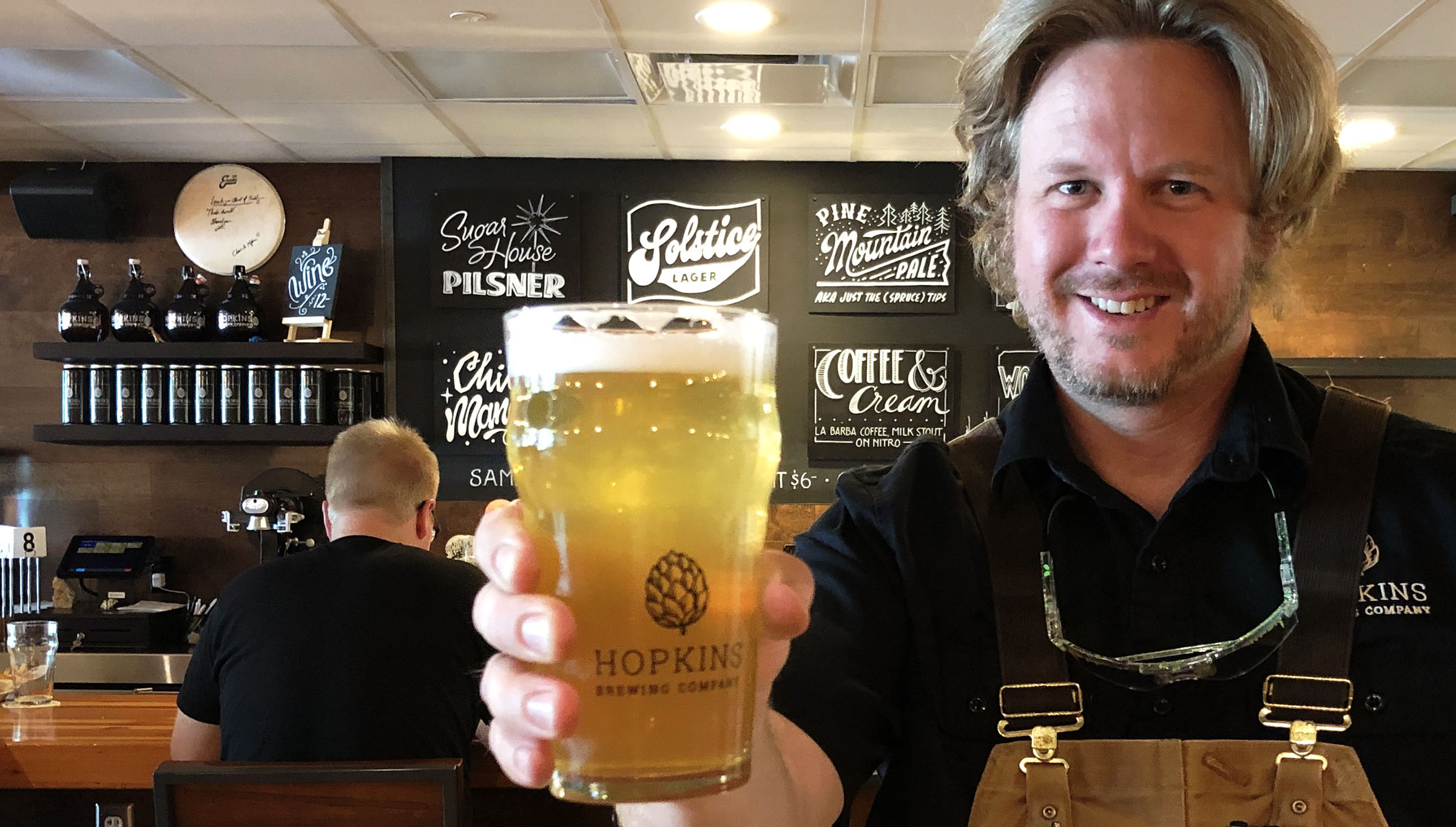 Chad Hopkins, brewer at Hopkins Brewing Co. in Salt Lake City, and a pint of his Sugar House Pilsner. He grew up a mile from where his brewpub now stands.