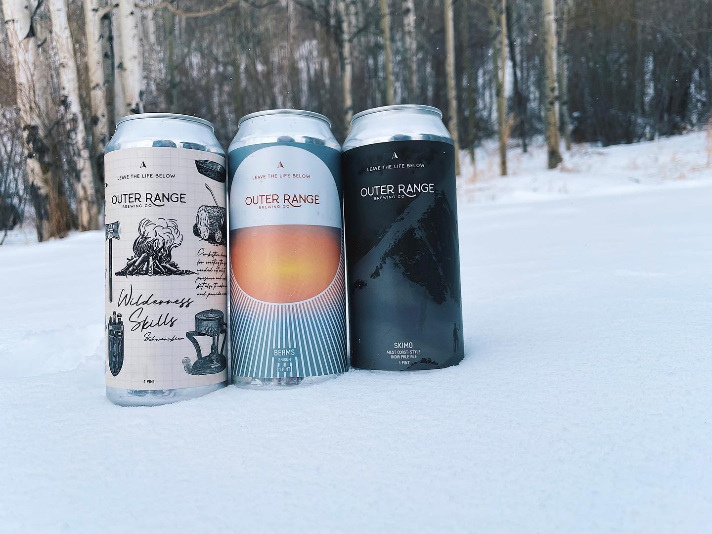 Outer Range Brewing cans in snow